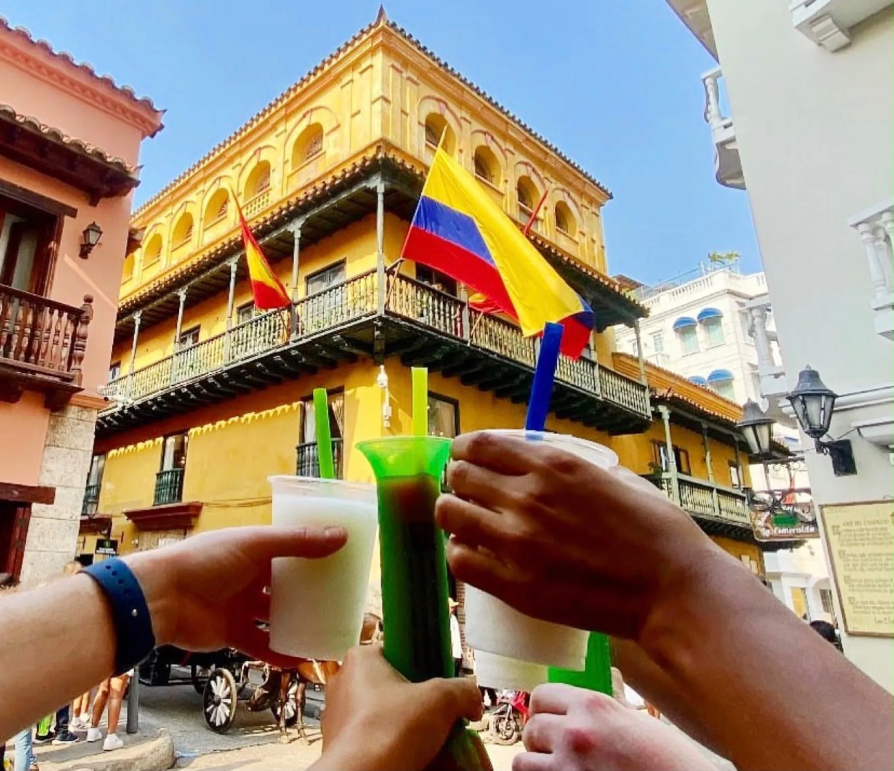 Friends raising drinks in Cartagena